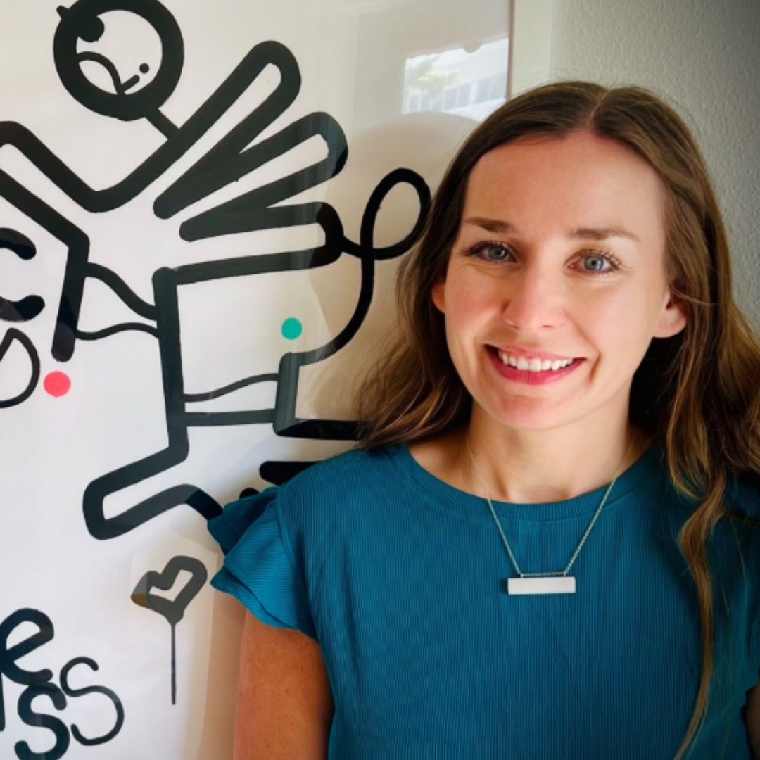 jessica levan, smiling in front of art piece