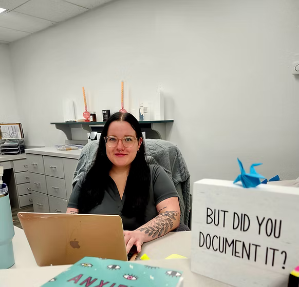 shaye, lady sitting in front of laptop
