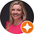 a lady smiling, wearing pink